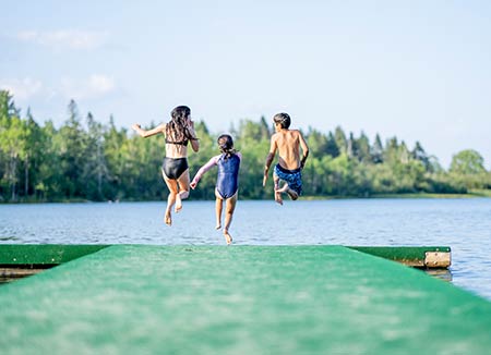 Children jumping in a lake to swim