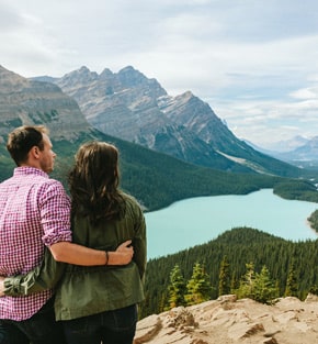 Couple admiring Peyto Lake from a rock