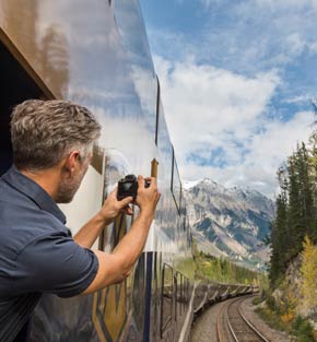 A guest aboard Rocky Mountaineer taking pictures