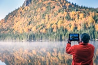 Man taking a picture of the Canadian scenery
