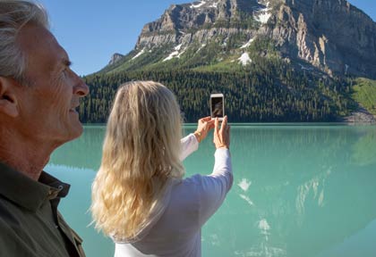 Couple taking pictures of Lake Louise